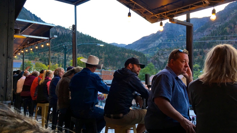 street watchers on the rooftop at Ouray Brewery